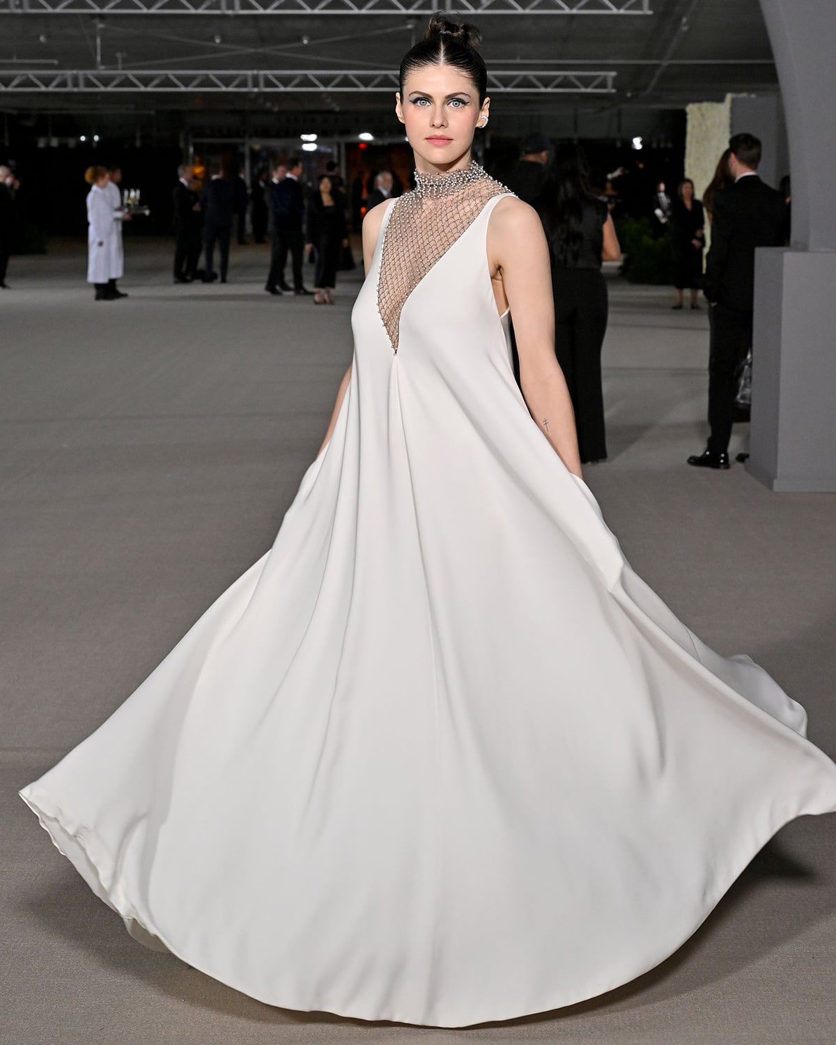 Alexandra Daddario wows in an effortlessly chic white gown with a pearl- and fishnet-embroidered breastplate by Dior