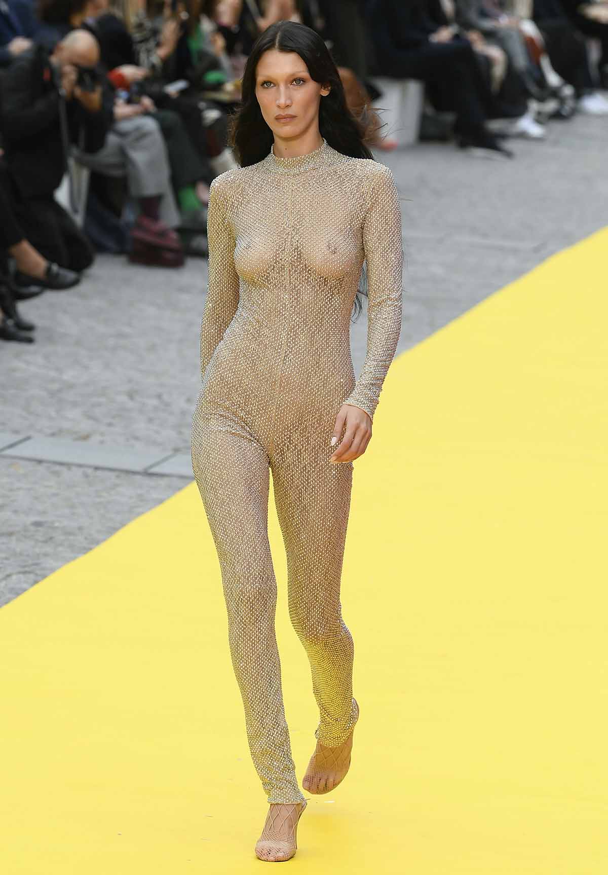 Bella Hadid goes braless underneath a sheer nude embellished unitard for Stella McCartney
