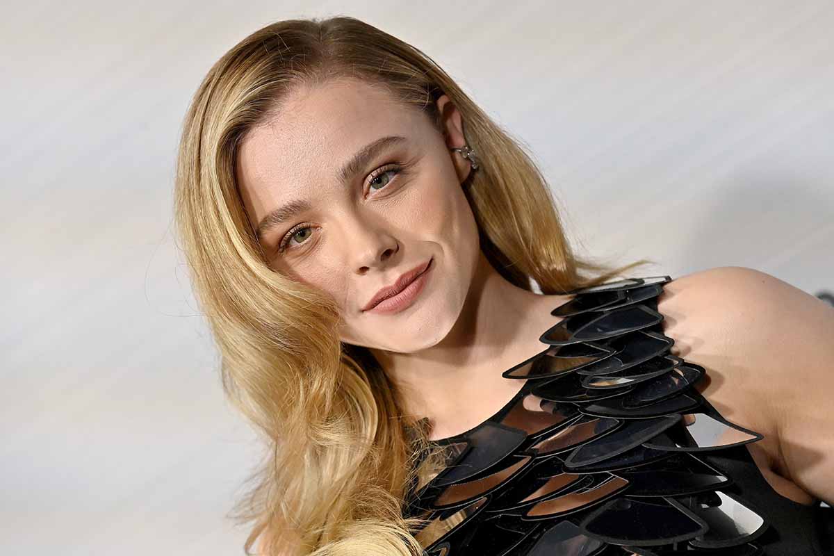 Chloe Moretz wears light pink makeup and styles her tresses in side-parted waves