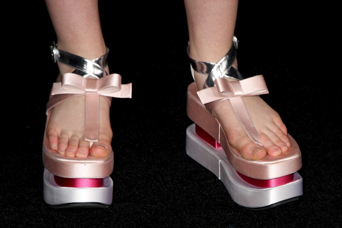 Elle Fanning steps out in eye-catching Prada platform heels featuring metallic straps and feminine bow details