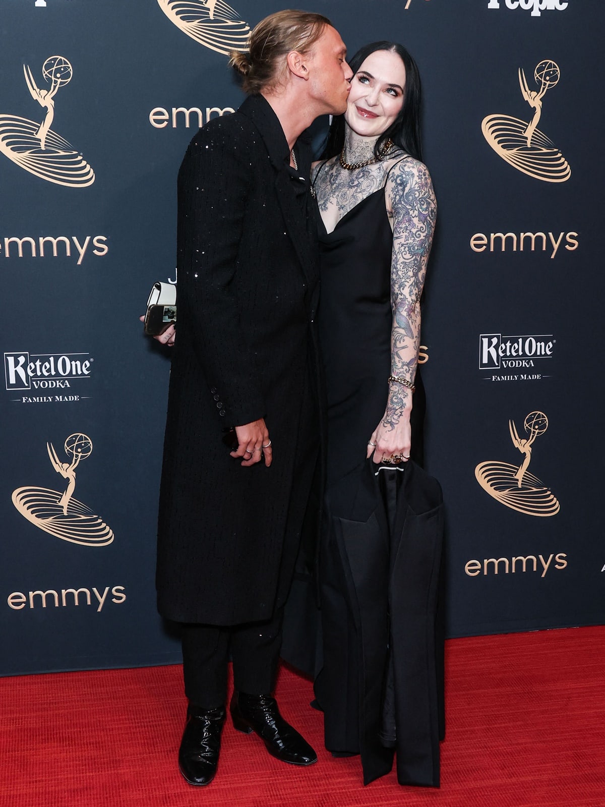 Jamie Campbell Bower kisses his girlfriend Jess Moloney on the red carpet at the 74th Primetime Emmy Awards Performers Nominee Reception