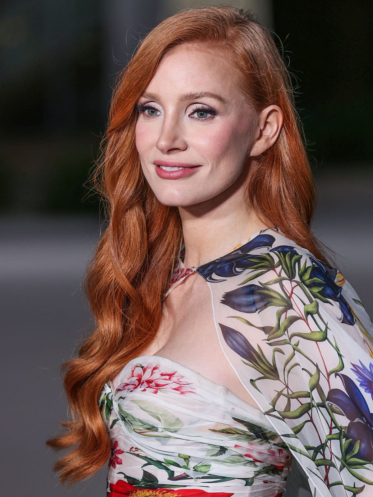 Jessica Chastain wears a full face of makeup and styles her auburn tresses in Old Hollywood waves