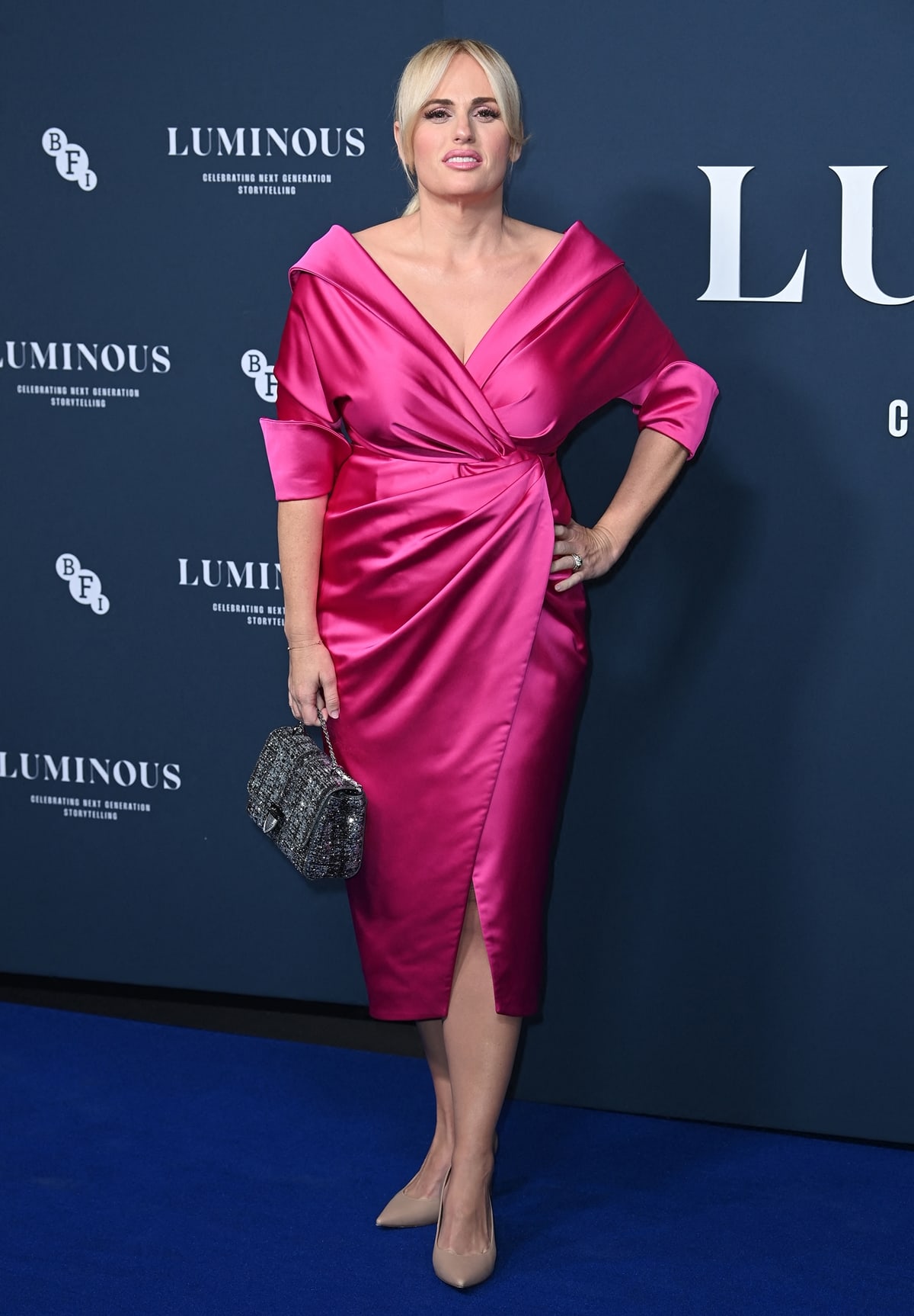 Rebel Wilson in a hot pink Rhea Costa wrap midi dress at the BFI London Film Festival Luminous Gala