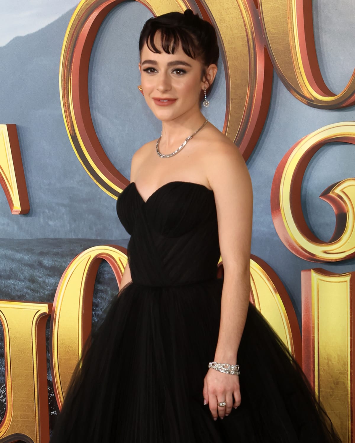 Sophia Anne Caruso wears Audrey Hepburn hairstyle and accessorizes with Neil Lane jewelry