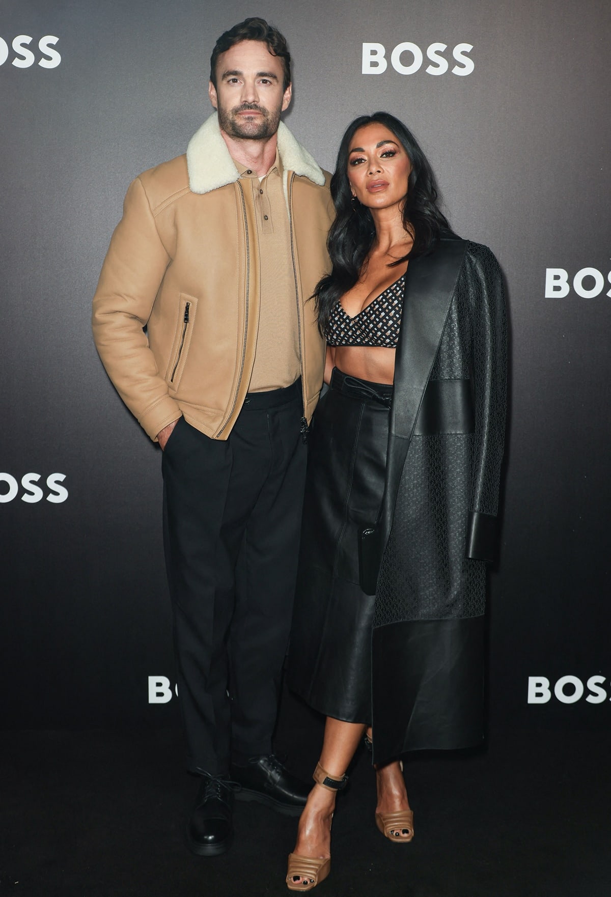 Nicole Scherzinger and her boyfriend, Thom Evans, highlight their height difference (approximately 9 inches) at the Boss Fashion Show during the Milan Fashion Week Womenswear Spring/Summer 2023
