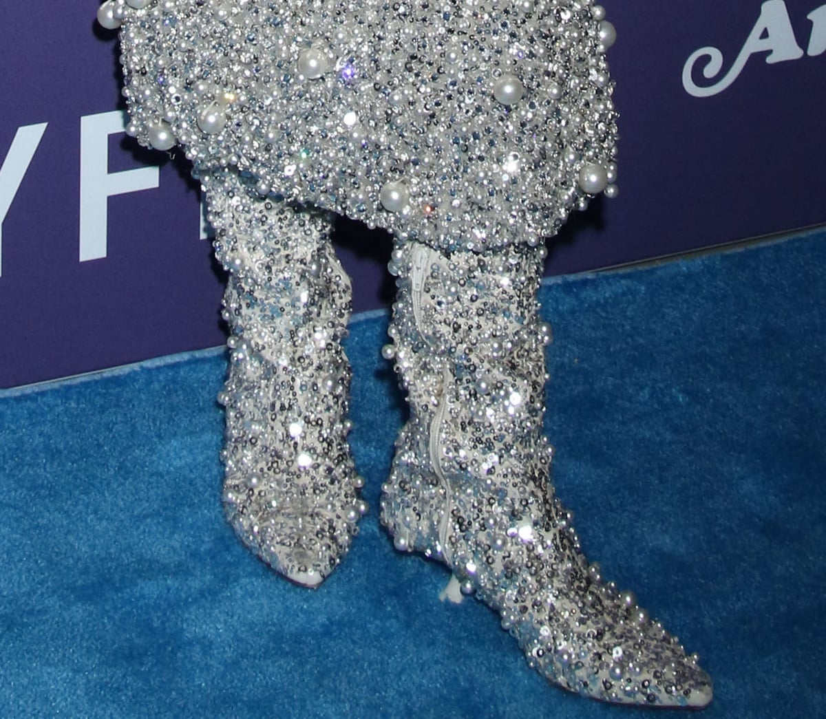 Anne Hathaway wore the matching Valentino fully embellished boots to round out her premiere look