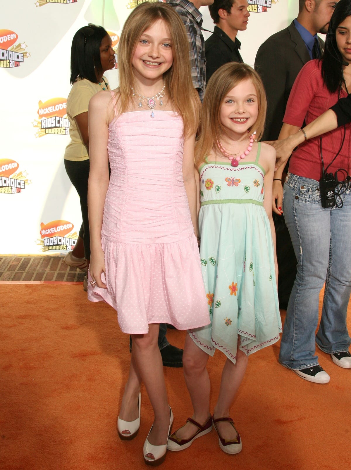 Dakota and Elle Fanning charm on the orange carpet in sweet pastel dresses, showcasing their youthful style at the Nickelodeon Kids' Choice Awards