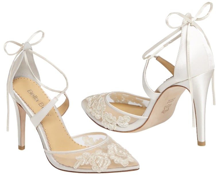 Floral Alençon lace blooms on a bed of ivory illusion mesh at the pointy toe of a wedding pump that comes complete with silk-tie straps