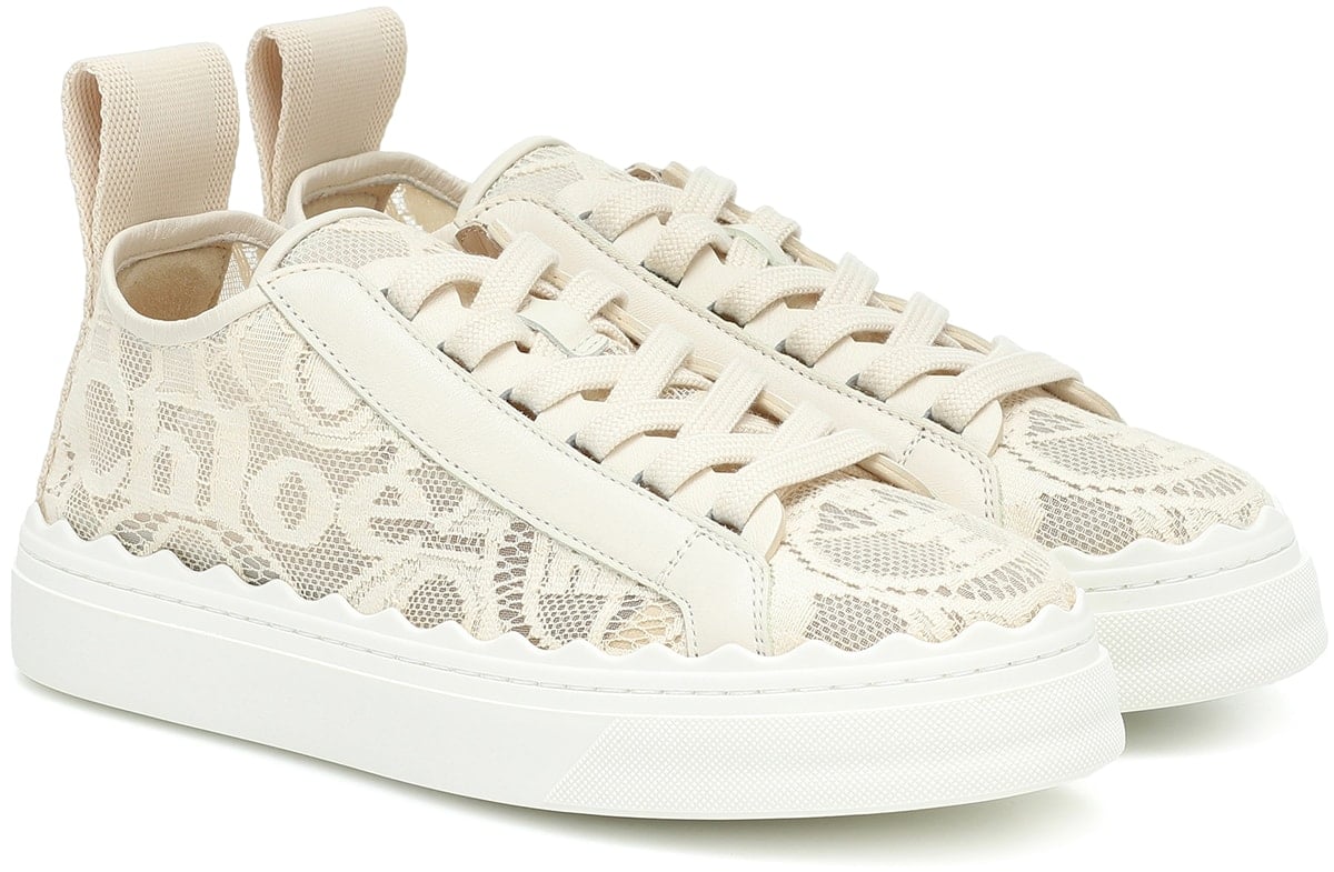 For day-to-evening comfort, opt for Chloé's Lauren sneakers, featuring an intricate, logo-adorned lace upper, scalloped trims, and elevated soles
