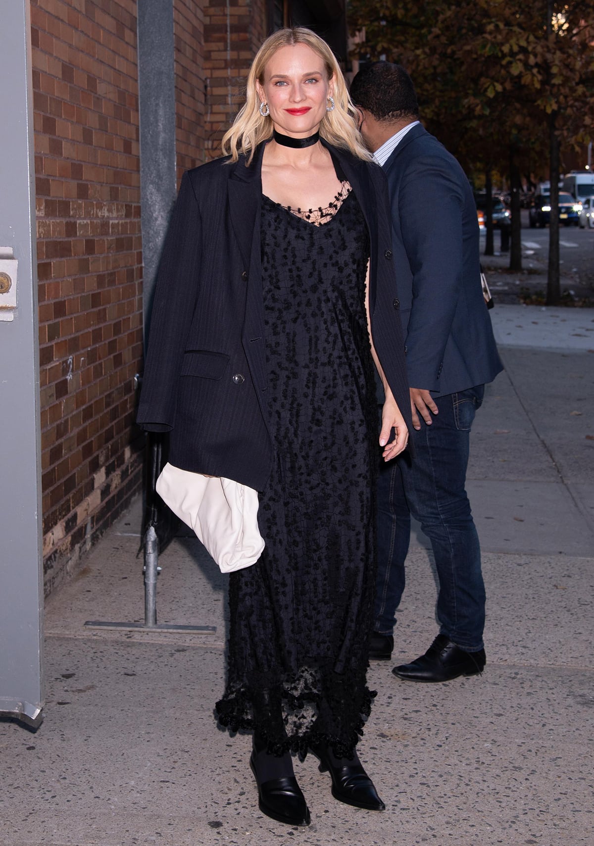 Diane Kruger promotes her children's book in a black maxi dress with netted overlay by Jil Sander at The Daily Show with Trevor Noah on October 27, 2022