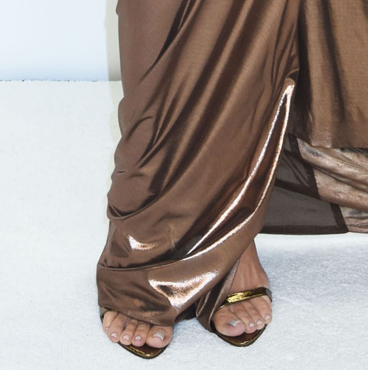 Khloe Kardashian shows off her pedicured feet in gold Tom Ford heels