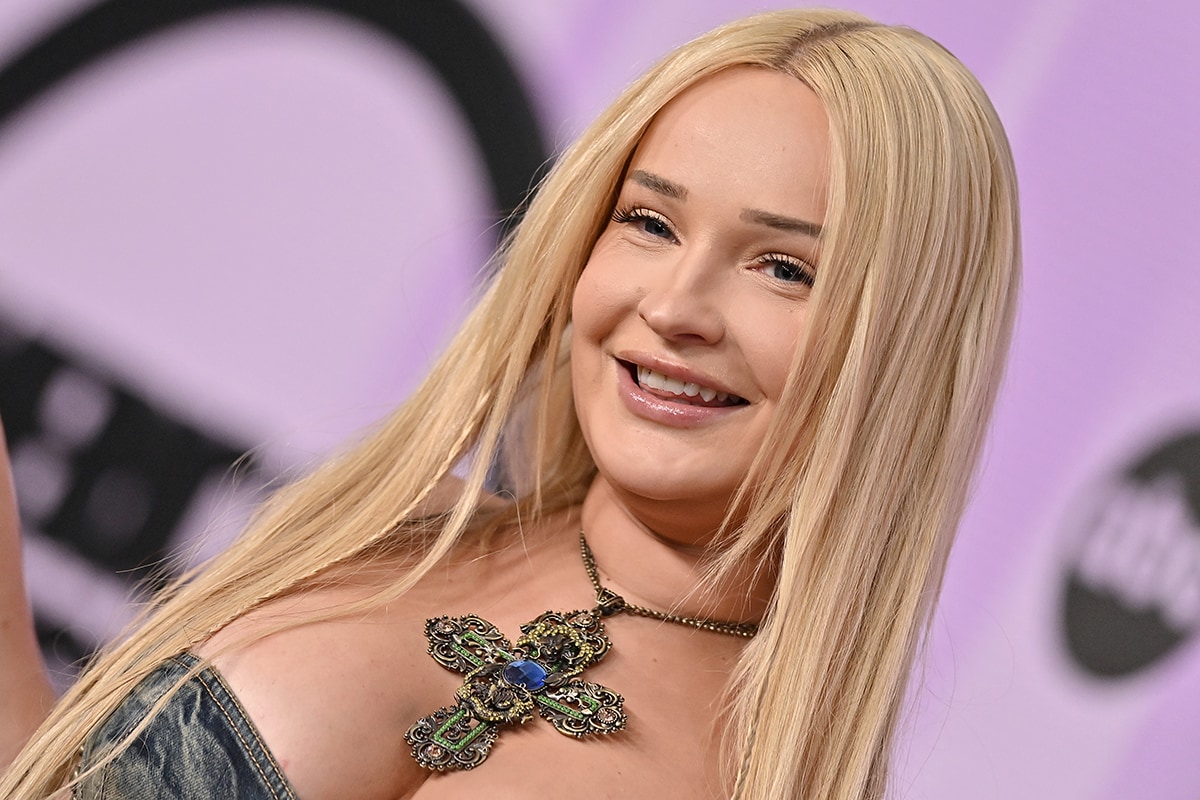 Kim Petras wears minimal makeup and styles her long blonde tresses straight