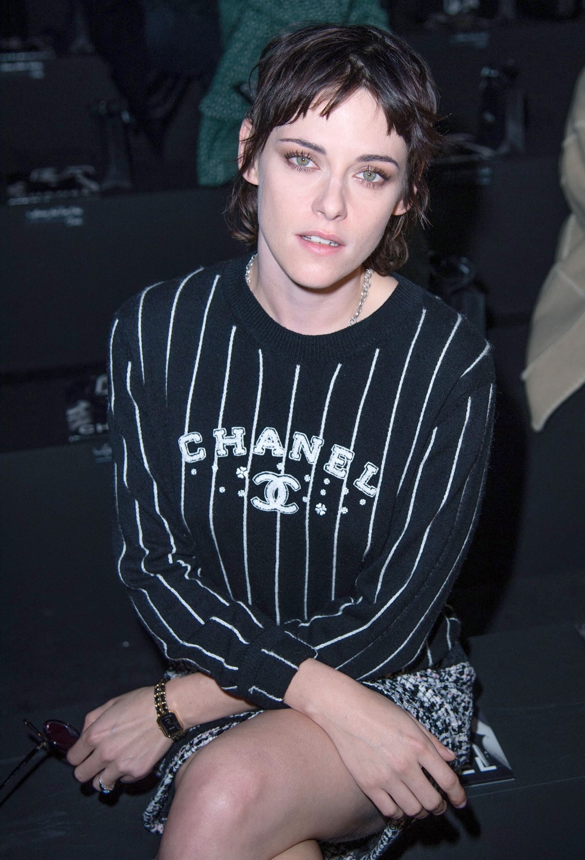 Kristen Stewart wears a black-and-white striped Chanel sweater with a tweed skirt