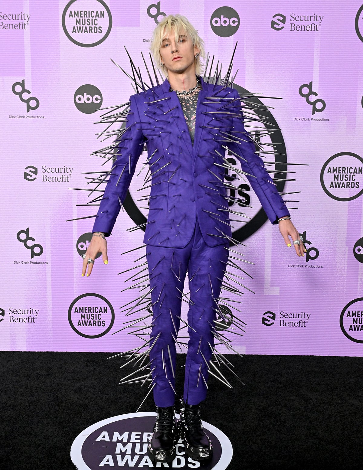 Machine Gun Kelly takes home the Favorite Rock Artist award in a purple suit embellished with long gunmetal spikes