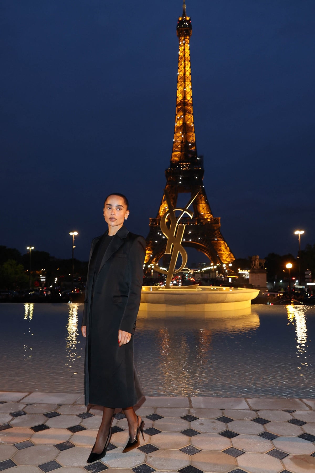 Zoë Kravitz exudes Parisian chic in a sleek black ensemble and sheer slingback heels while attending the Saint Laurent Womenswear Spring/Summer 2023 show during Paris Fashion Week on September 27, 2022