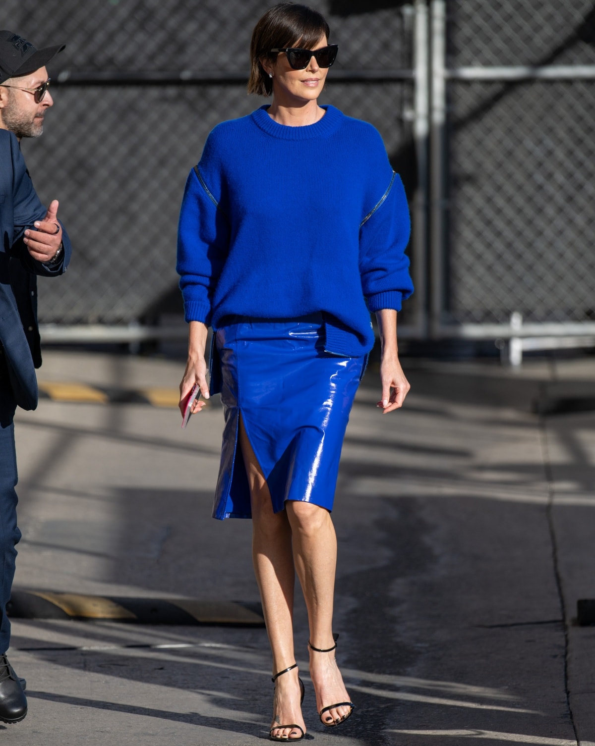 Charlize Theron in an all-blue outfit with ankle-strap heels outside the Jimmy Kimmel Live studios