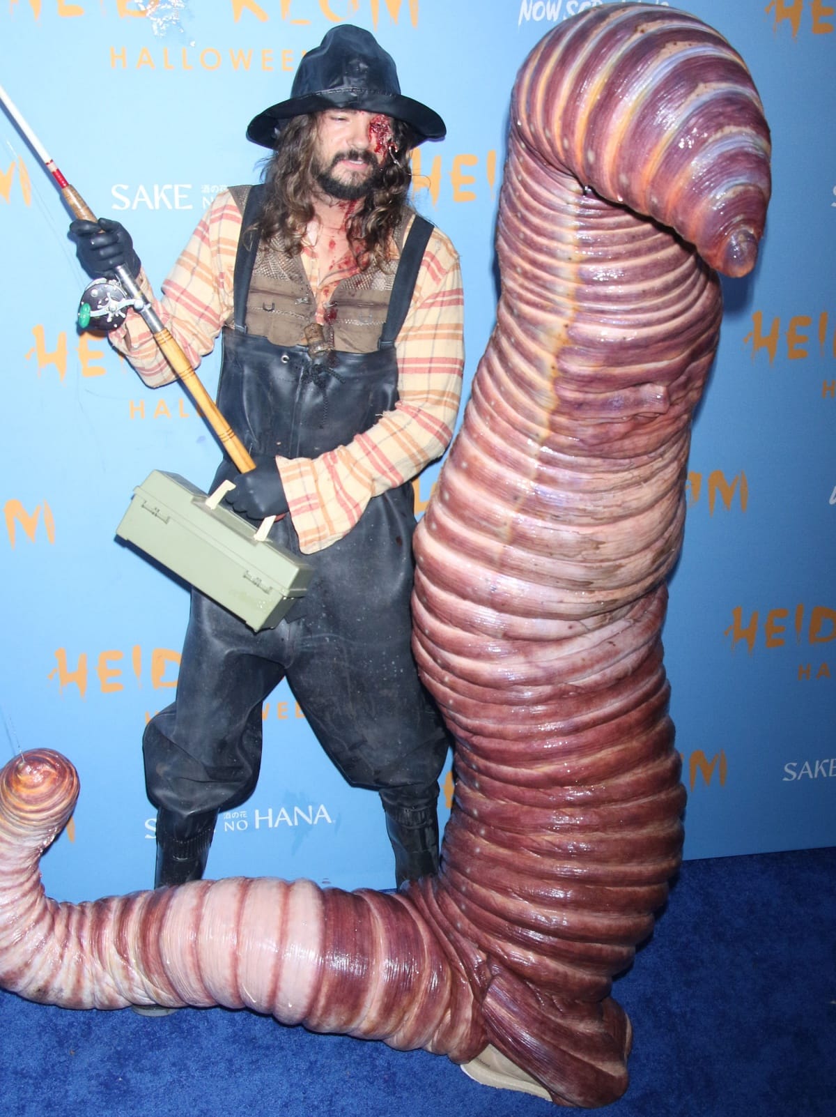 Tom Kaulitz as a fisherman and Heidi Klum as bait at their Halloween party