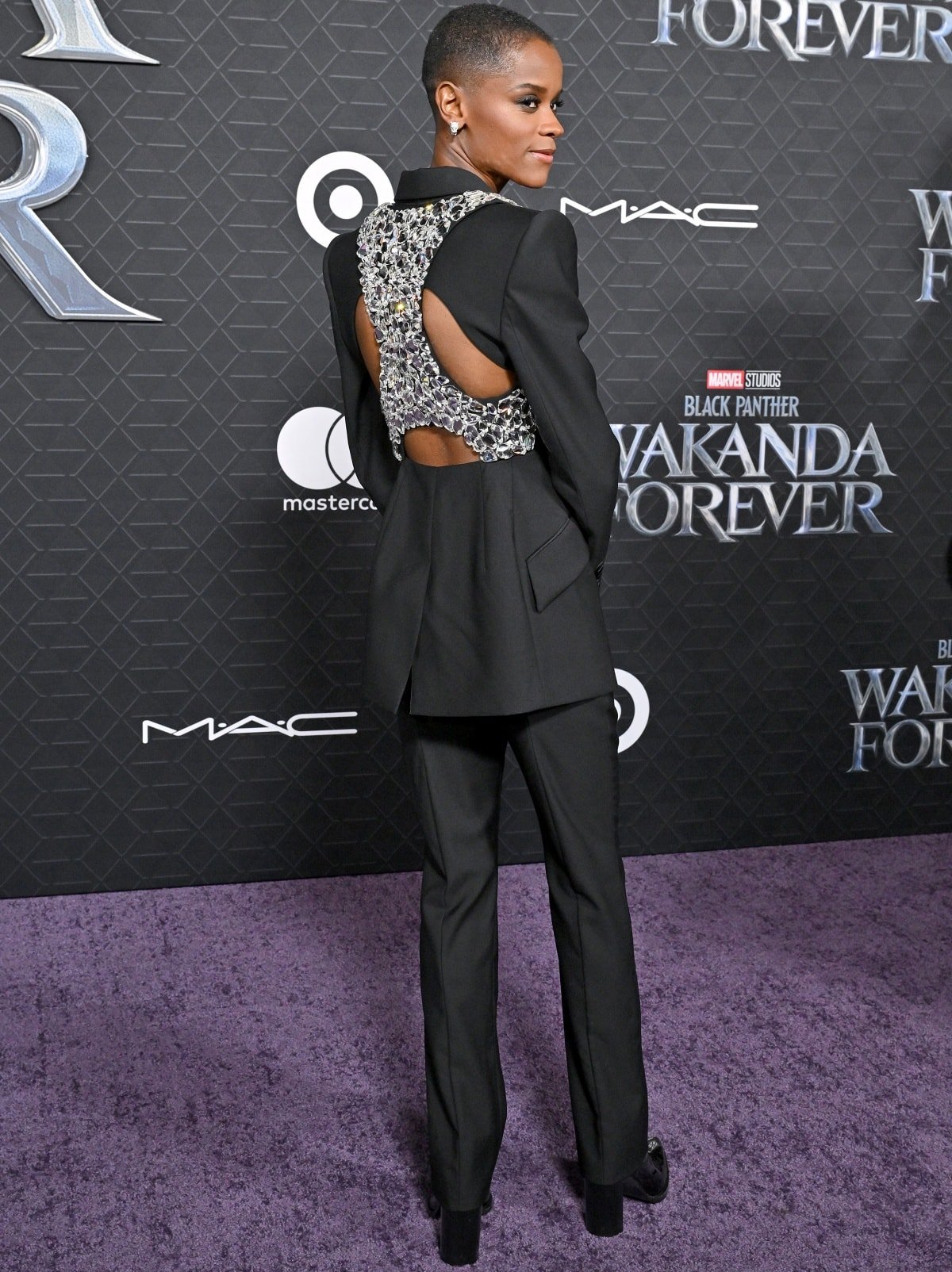 Letitia Wright showing off the crystal harness on her Alexander McQueen suit