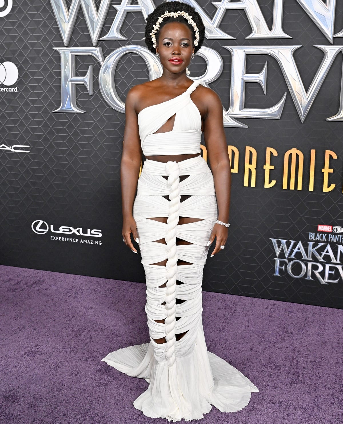 Lupita Nyong’o wearing a custom white braided dress from Balmain with De Beers Jewellers diamonds and a seashell headband