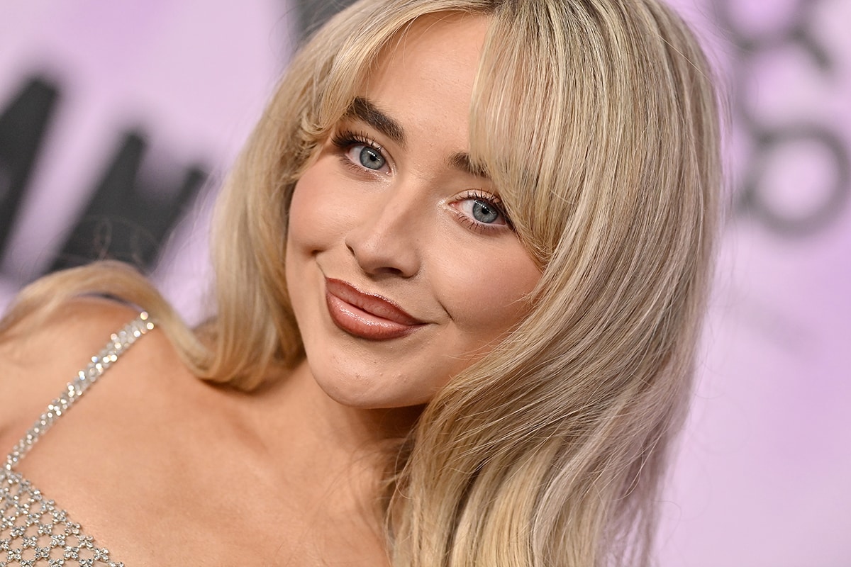Sabrina Carpenter keeps the look flirty with bombshell waves and ombre lips