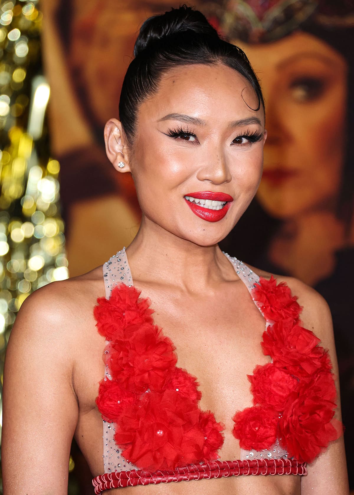 Li Jun Li wears HausLabs makeup, with red coral lipstick, winged eyeliner, and bronzed eyeshadow