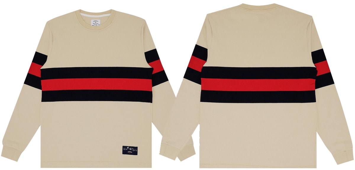 A classy take on the classic rugby crewneck, this Noah creation is done in Vegas Gold with navy and dark red stripes across the front and sleeves