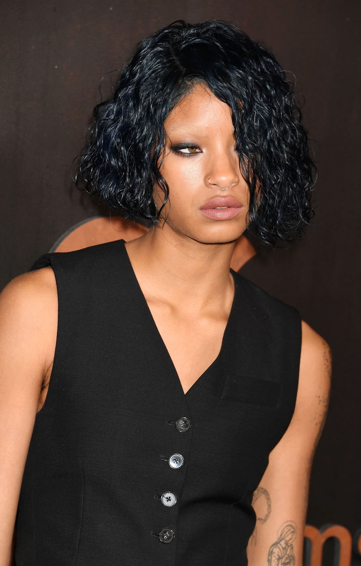 Willow Smith with shaved eyebrows and curly-tousled hair