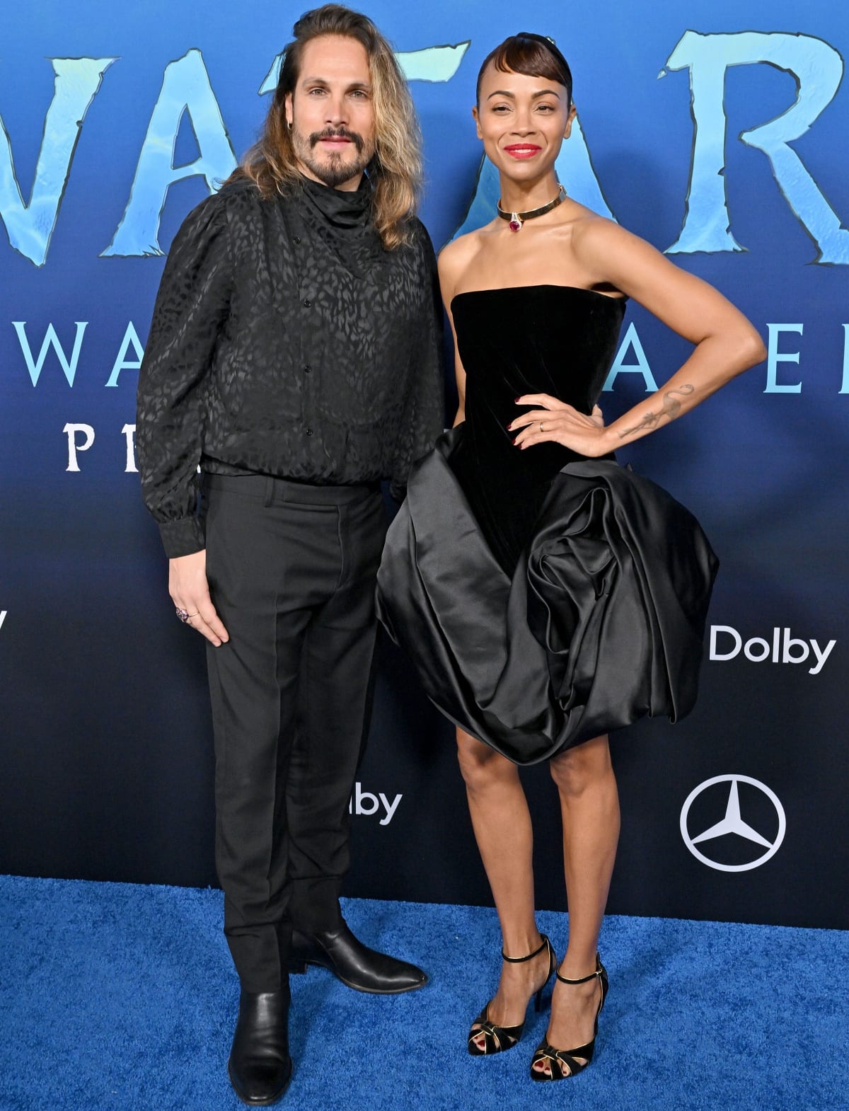 Zoe Saldana with husband Marco Perego in matching all-black looks at the Los Angeles premiere of Avatar: The Way of Water