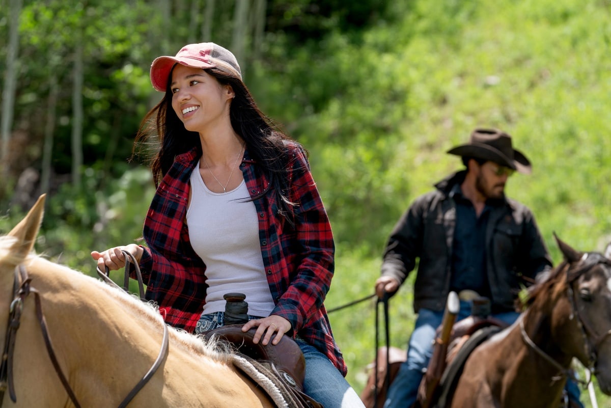 Kelsey Asbille, despite admitting she’s "terrible" at horseback riding, looks at ease in a laid-back flannel and baseball cap