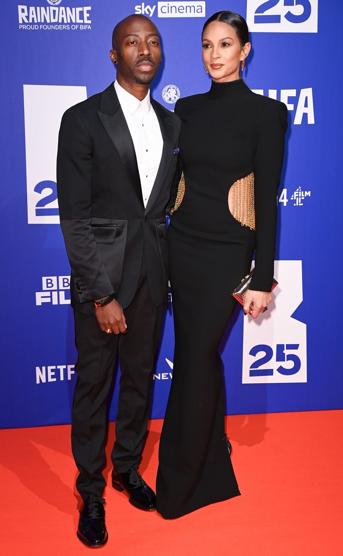 Alesha Dixon, in a black Jean-Louis Sabaji gold chain dress, and her husband Azuka Ononye attend the British Independent Film Awards 2022