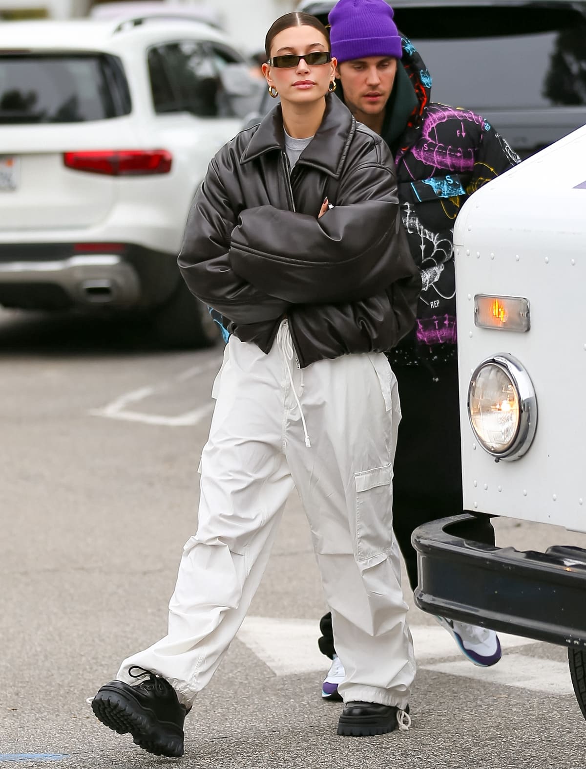 Hailey Bieber elevates her style with an Acne Studios bomber jacket, Local European Le Cargo pants, and sleek Eytys Angel sneakers