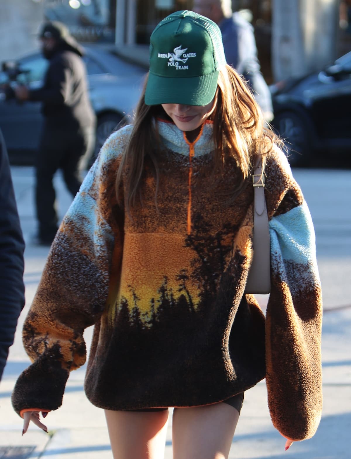Hailey Bieber in an orange Conner Ives Hudson River School acrylic-blend sherpa fleece sweater