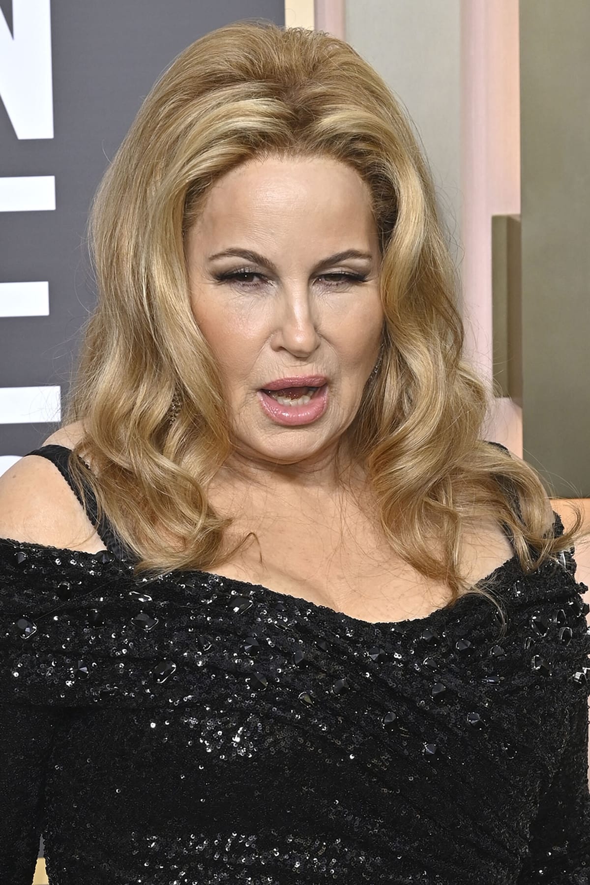 Jennifer Coolidge's voluminous and teased hairstyle was curled into loose waves, adding a touch of glamour to her overall look