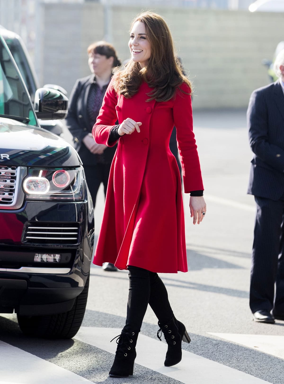Kate Middleton arrived in Northern Ireland for a two-day trip, sporting a recycled red Carolina Herrera coat dress paired with black leggings and L.K. Bennett ankle booties, as she visited Windsor Park Stadium, home of the Irish Football Association, on February 27, 2019, in Belfast, Northern Ireland