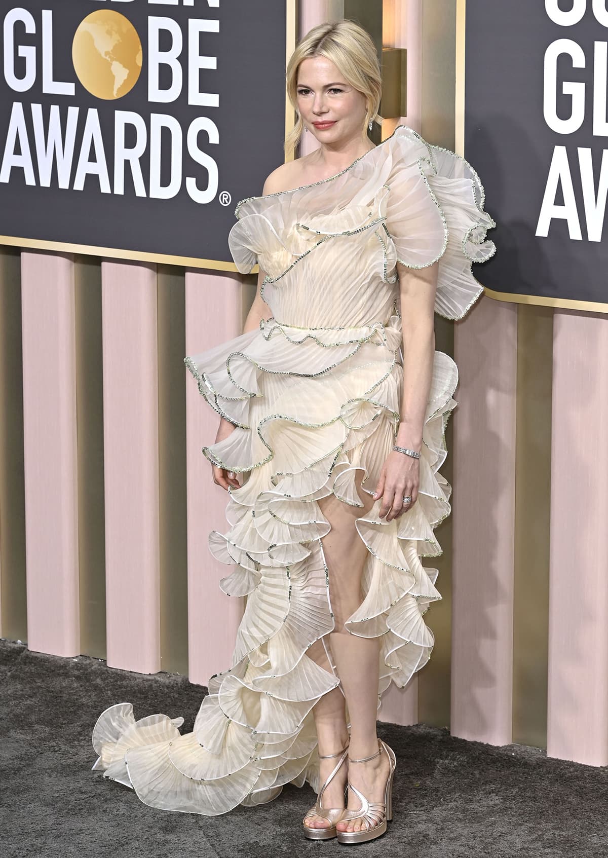 Michelle Williams highlights her flawless complexion in Gucci's pale yellow ruffled gown and platform heels