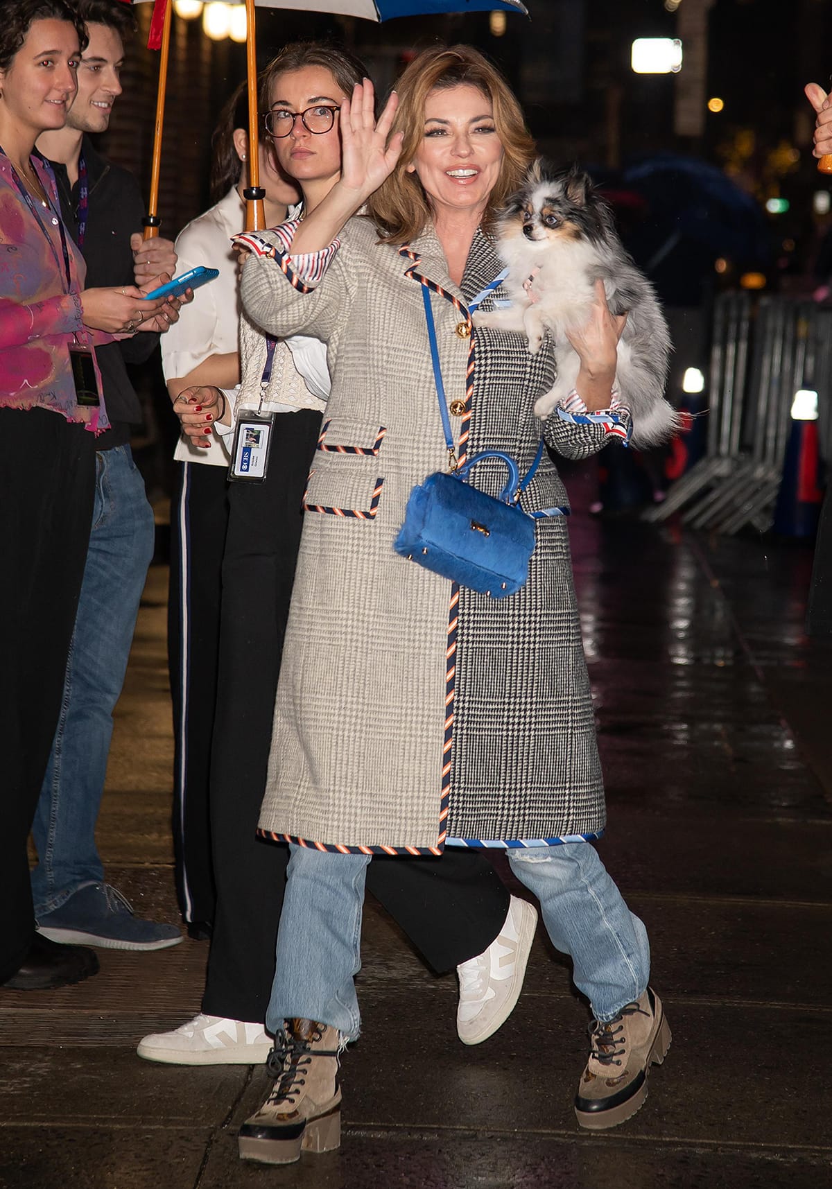 Shania Twain covers up in a multi-patterned coat with jeans and a pair of lace-up platform boots for her appearance on The Late Show with Stephen Colbert on January 4, 2023