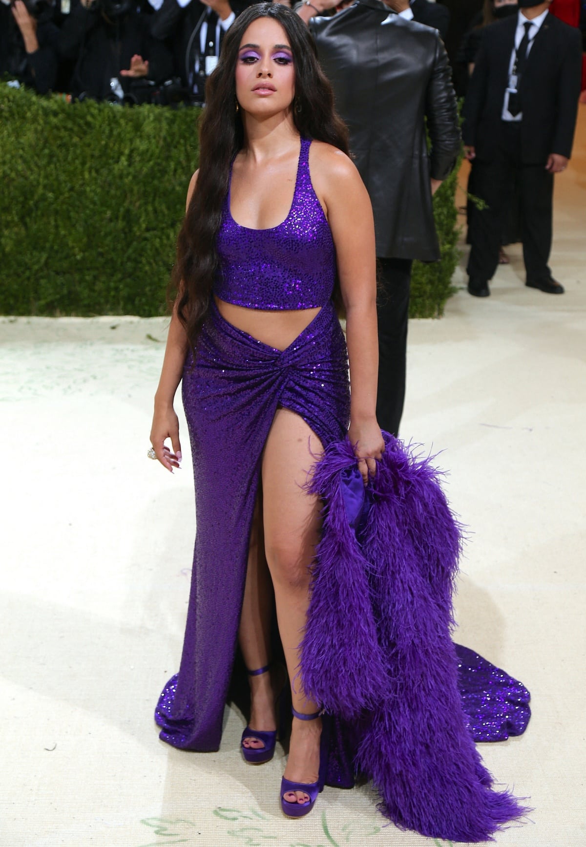 Camila Cabello wearing a cleavage-baring crop top, a matching floor-sweeping skirt with a thigh-high slit, and high platform heels at the 2021 Met Gala