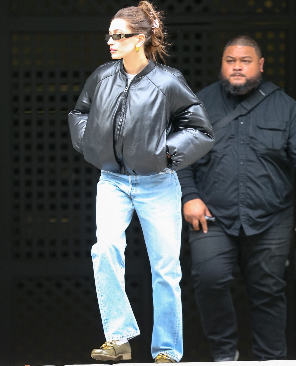 Hailey Bieber looking casual-cool in a bomber jacket with jeans and a pair of loafers