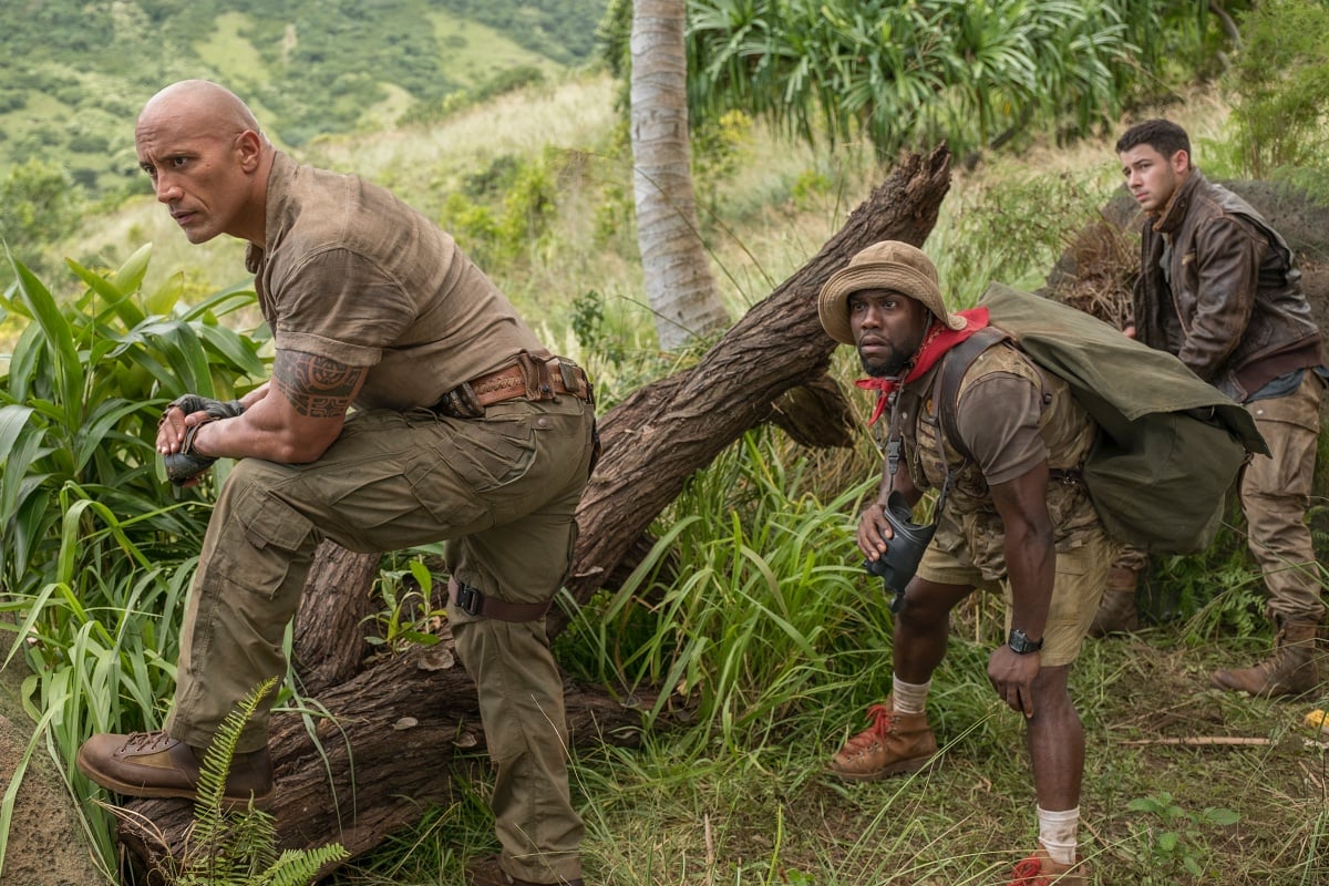 Dwayne Johnson as Dr. Xander “Smolder” Bravestone, Kevin Hart as Franklin “Mouse” Finbar, and Nick Jonas as Jefferson “Seaplane” McDonough in the 2017 fantasy adventure comedy film Jumanji: Welcome to the Jungle