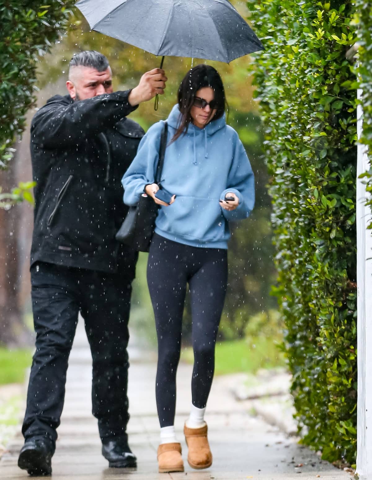Kendall Jenner’s bodyguard getting soaked while he held the umbrella over her head to protect her from the rain