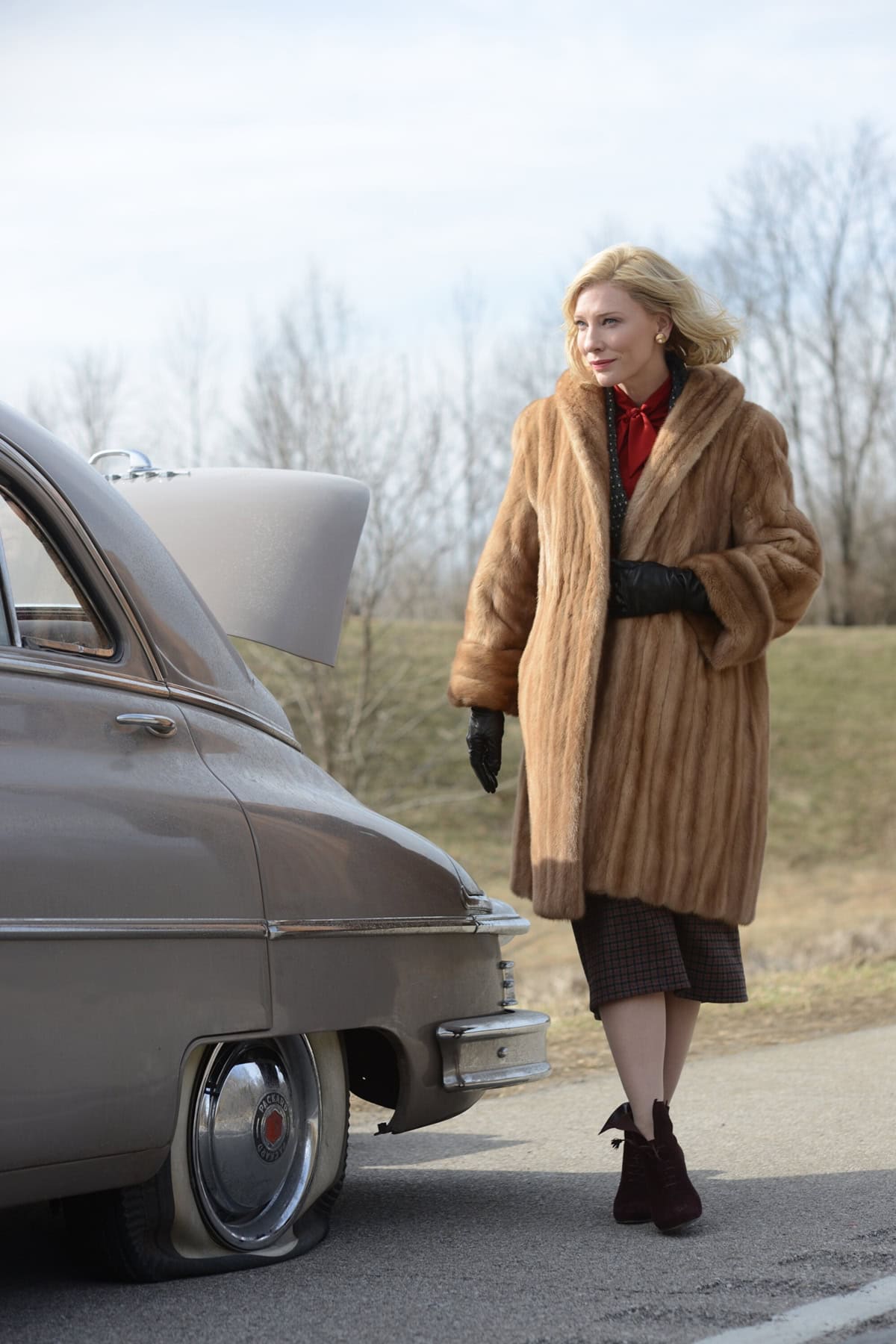Cate Blanchett channels 1950s elegance in a mink coat and Ferragamo lace-up ankle boots, capturing Carol Aird’s poised sophistication with every step
