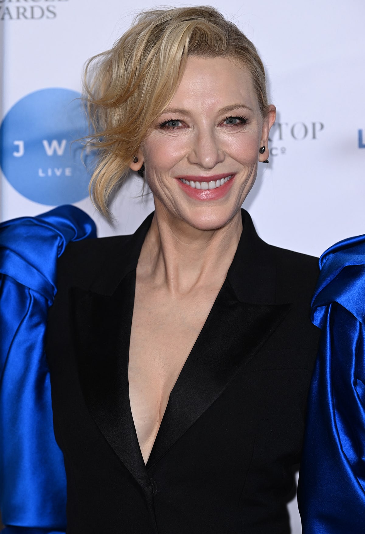 Cate Blanchett sweeps her fringe to the side and wears smudged eye-makeup with pink lipstick