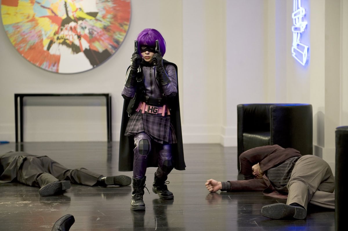 Chloë Grace Moretz’s Hit-Girl look blends tactical strength with playful flair—complete with a purple wig, pleated skirt, and sturdy black combat boots designed for real action scenes
