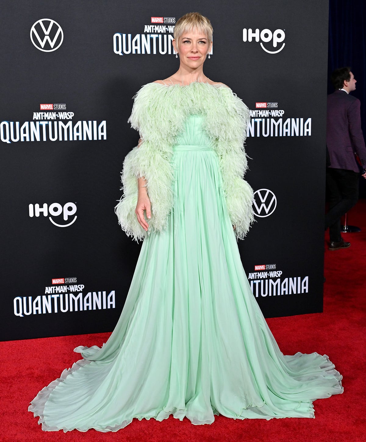 Evangeline Lilly arrives at the Los Angeles premiere of Ant-Man and the Wasp: Quantumania in a stunning green feathered gown on February 6, 2023