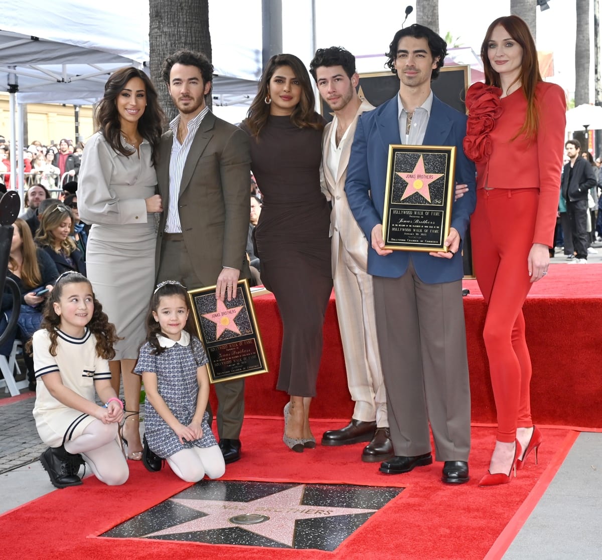 Danielle Jonas, Kevin Jonas, Priyanka Chopra, Nick Jonas, Joe Jonas, Sophie Turner, and (front) Alena Rose Jonas and Valentina Angelina Jonas attend The Hollywood Walk of Fame star ceremony honoring The Jonas Brothers