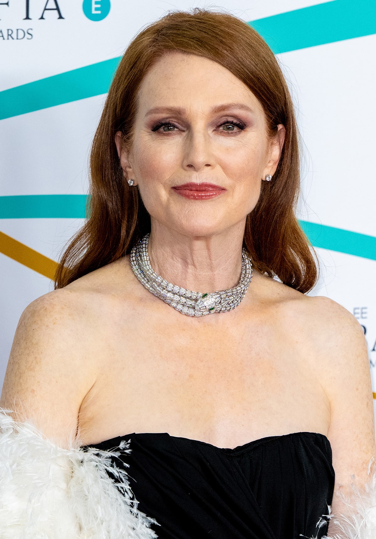 Julianne Moore wears her tresses in side-parted waves with glamorous makeup that highlights her eyes