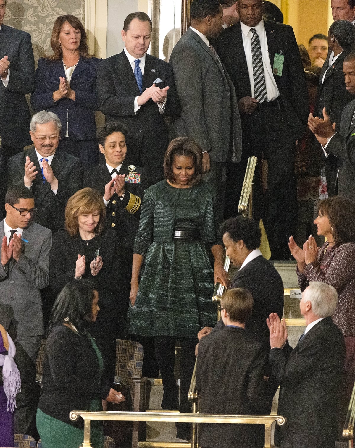 In 2014, Michelle Obama wore a textured, forest green Azzedine Alaia dress with a fitted bodice, A-line skirt, and a wide, black leather belt to the State of the Union address, which received praise for its conservative yet elegant style