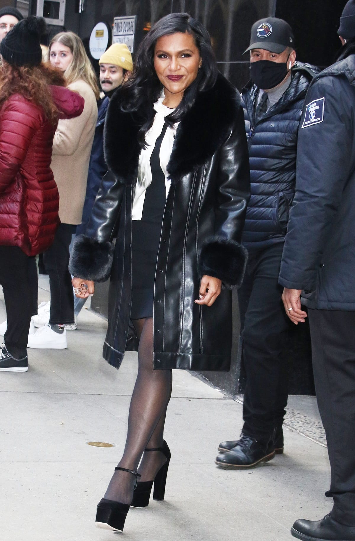 Mindy Kaling looked stunning in an ALICE + OLIVIA Stari vegan leather faux fur coat, a Gucci bow-accented dress, and Giuseppe Zanotti Bebe heeled sandals