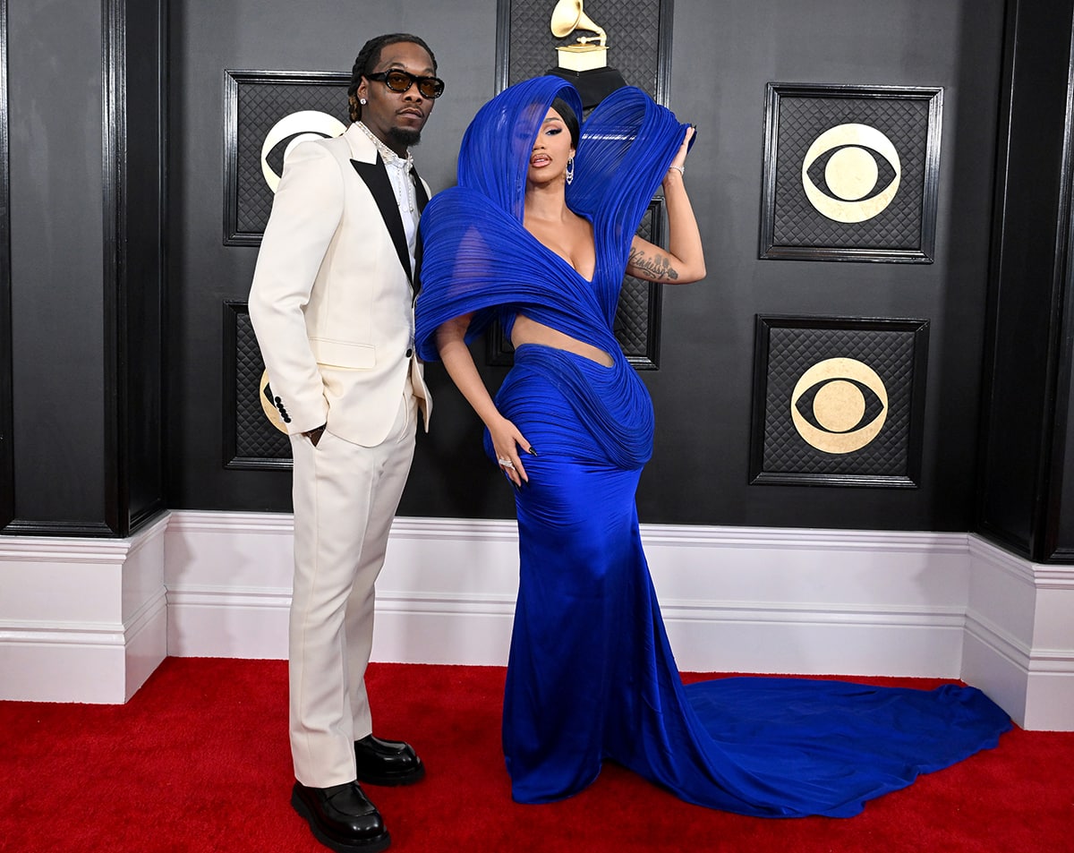 Offset poses with wife Cardi B in a white suit with black lapels, styled with chunky boots and a pearl necklace