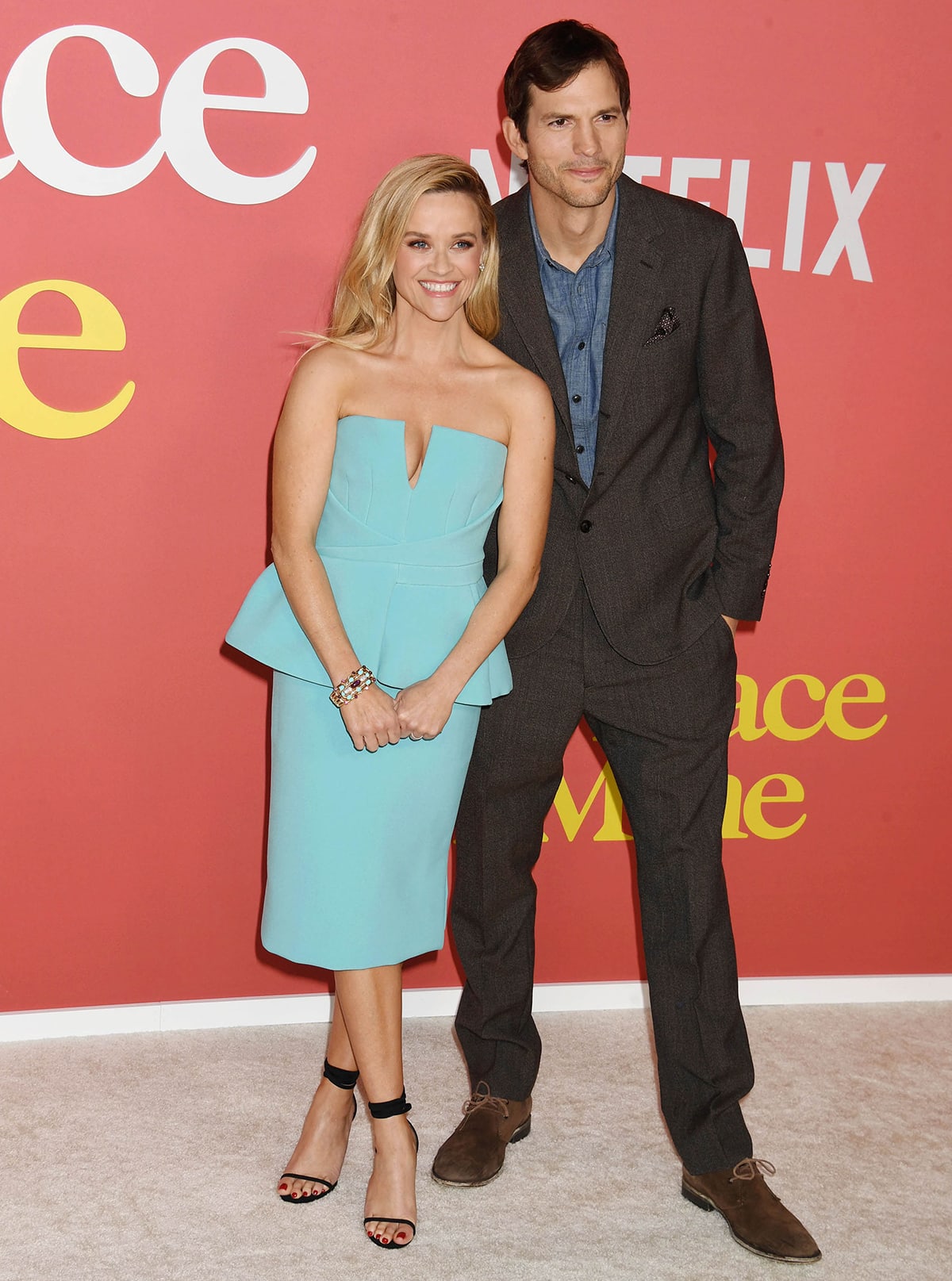 Ashton Kutcher looks dapper in a blazer suit as he poses alongside his on-screen partner Reese Witherspoon at the Los Angeles premiere of Your Place or Mine at Regency Village Theatre on February 3, 2023